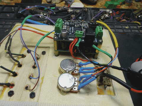 the amp module on the desk showing the adafruit boards and connections