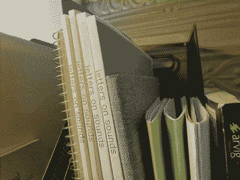 Several booklets with the words Letters On Sounds are stacked alongside other documents in a magazine holder.